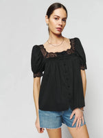 Load image into Gallery viewer, Introducing the Wanda Top from Reformation - the perfect addition to your wardrobe for effortless style. With a relaxed fit and a square neckline, this top exudes a casual yet chic vibe. Plus, the short puff sleeves add a touch of femininity. Shop now and elevate your look with ease.
