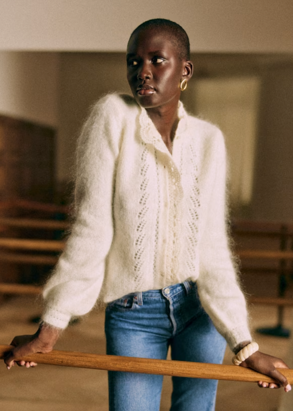 Indulge in luxury with the Cárdigan Angie. Made from a blend of wool and kid mohair, this cardigan boasts a delicately fluted silhouette and intricate crochet detailing along the button placket and neckline. The open-knit front adds a touch of artful elegance. Elevate your wardrobe with this timeless piece.