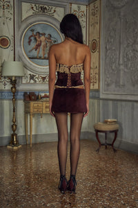 Indulge in opulence with the Victorian Velvet Set. The velvet corset boasts a delicate lace trim and secure silicone gripper while the functional silk ties and bow add a touch of femininity. Boning throughout the bodice accentuates your figure. The matching mini skirt features hidden shorts and an invisible zipper for a seamless silhouette.