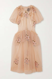 This floral-embroidered tulle midi dress by Simone Rocha embodies romance and elegance with its delicate sheer fabric and calf-length silhouette. Satin bows at the shoulders add a touch of refinement, while intricate floral embroidery, ruffled trims, and ruched details create a captivating, feminine look. Its flowing, loose skirt offers graceful movement, making it perfect for any special occasion where you want to stand out with timeless charm.