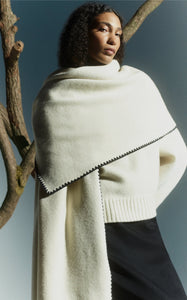 Embrace effortless Scandinavian style with this white wool-cashmere sweater by Totême. Crafted in a wide silhouette from mid-weight wool blended with cashmere, it offers cozy warmth and a soft touch. Intricate contrasting embroidery along the shoulders and armholes adds a refined, artisanal detail, elevating your everyday knitwear with subtle sophistication. Perfect for those who appreciate modern minimalism infused with a unique, handcrafted feel.
