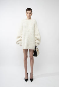 Elevate your wardrobe with the Gemini Sweater, a refined solid knit pullover designed to turn heads. Its daring backless style adds a touch of allure, while the loose fit and round neckline ensure all-day comfort. Long sleeves provide cozy warmth, making it the perfect blend of sophistication and ease. Step out confidently and make a memorable statement with this unique, stylish sweater.
