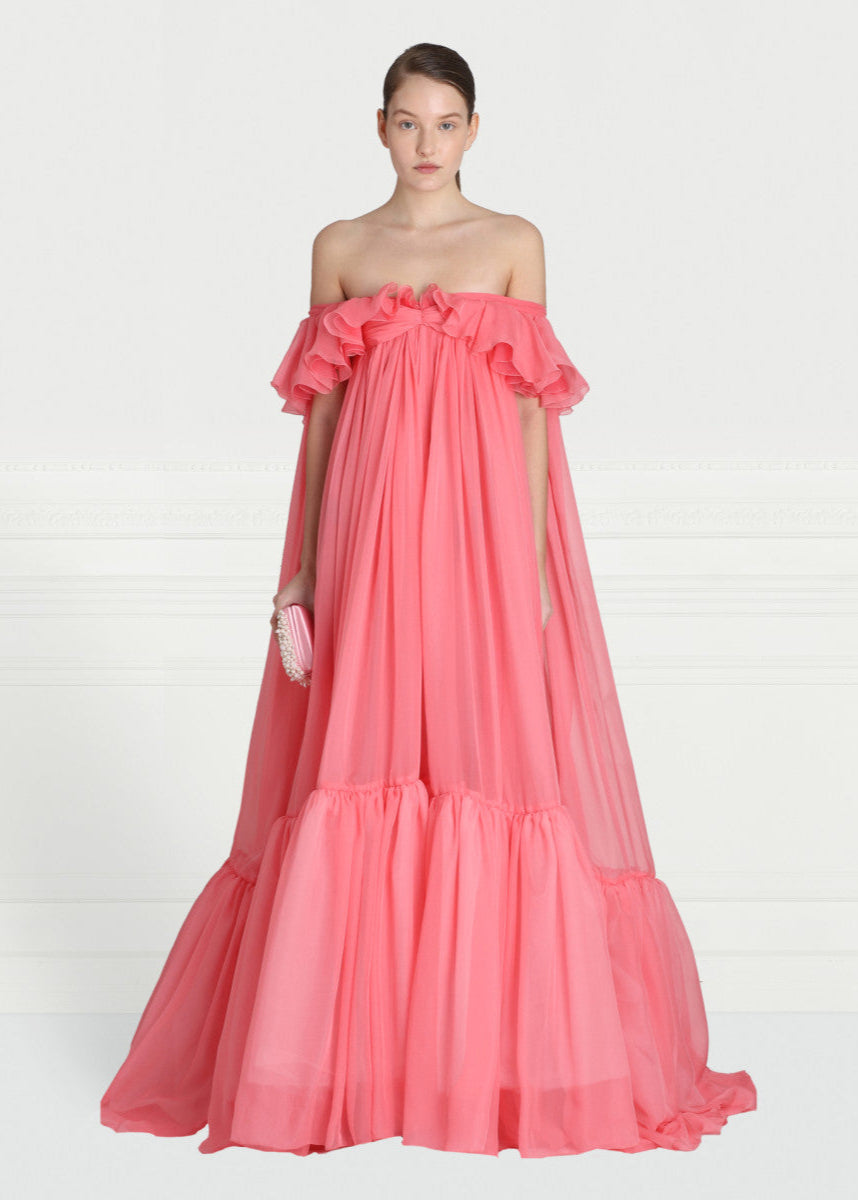 Get ready for a dreamy summer with this Off-shoulder Silk Georgette Gown from Giambattista Valli. Made with luxurious silk georgette, the fluid drape and flirty ruffle detail exude a romantic charm. Perfect for any special occasion, this exclusive gown will make you feel like a beautiful rosebud.