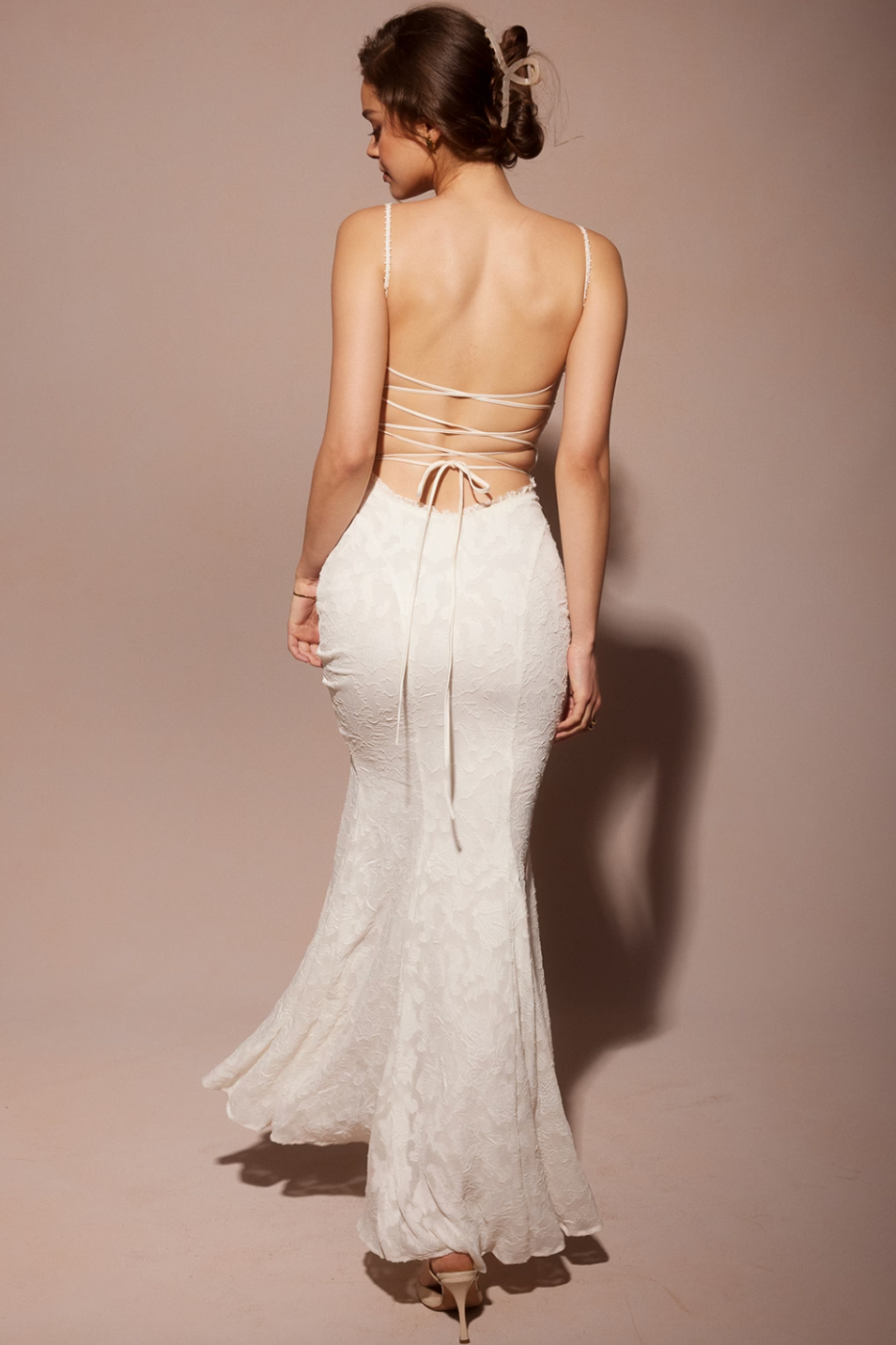 Experience elegance and allure with the expertly-crafted Abella Dress. Its stunning fishtail silhouette, intricate backless detail, and beautiful white lace make it perfect for any bride wanting to make a statement on her special day. Turn heads and feel confident in this timeless and elegant dress.