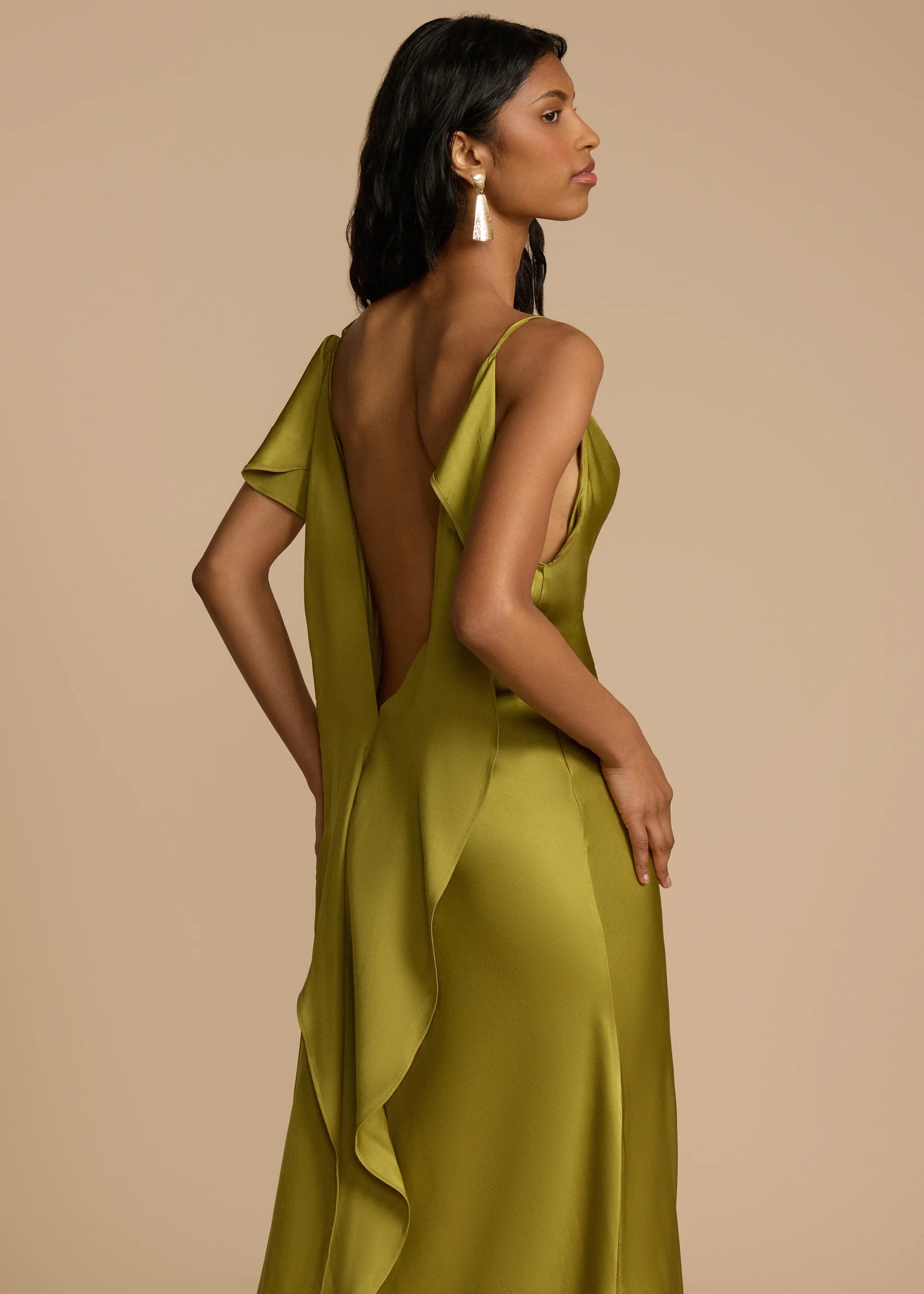 Looking for a dress that combines boldness and elegance? Look no further than the Odessa Dress! With subtle tucks at the side hip for structure and harmony, delicate spaghetti straps and a daring thigh-high slit, this dress is tailored to captivate. The asymmetrical deep V back and cascading satin details add the perfect finishing touches. Take a risk and stand out in the Odessa Dress.