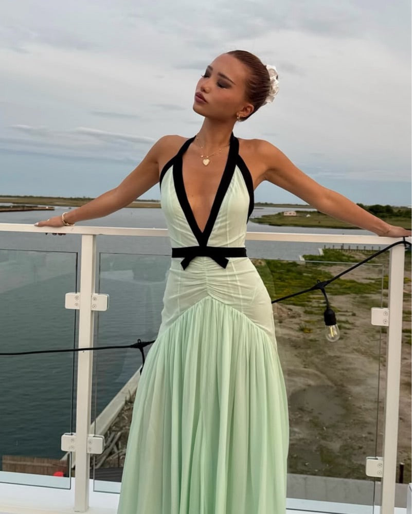 The Siren Dress in Mint by Helsa is engineered for those who embrace bold fashion statements. This sleeveless bodycon maxi features a striking plunging V-neckline and open back that exude confidence and allure. Contrast mesh patchwork adds contemporary visual interest, while pleated skirt detailing creates graceful movement. The secure halter construction delivers support without compromising the dress's daring aesthetic. 