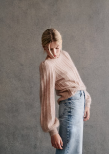 Stay cozy and chic in the Aretha Jumper. Made from a luxurious blend of wool and kid mohair, this jumper features long puffed sleeves and a boat neckline for a stylish and comfortable fit. The patterned knit adds a touch of texture, making it the perfect addition to your fall and winter wardrobe.