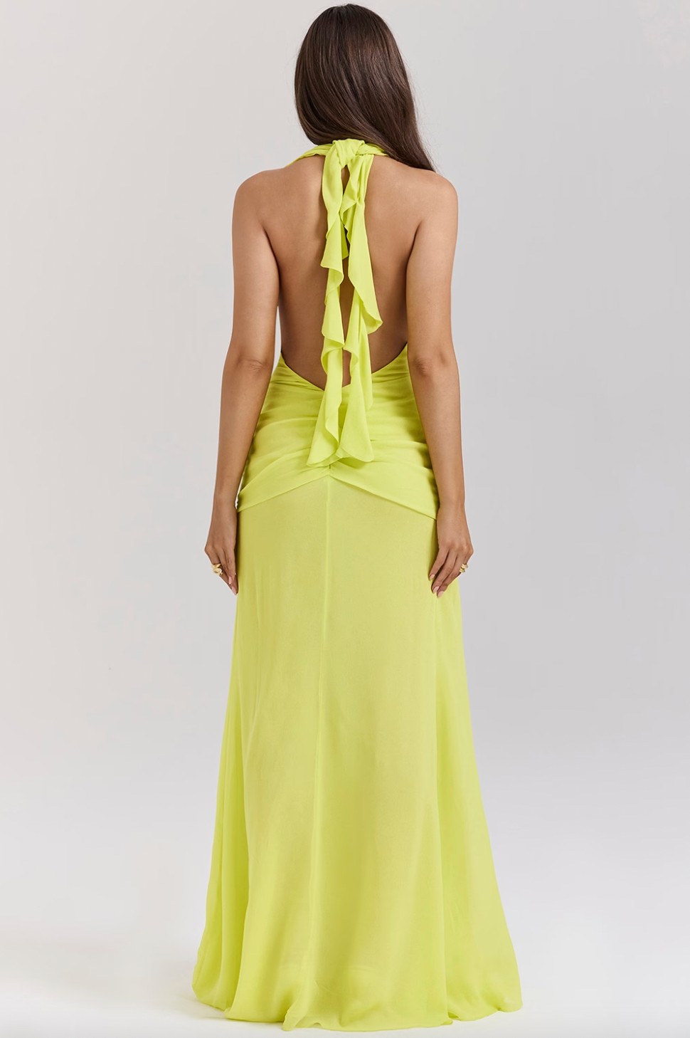 Elevate your style with the Backless Halter Maxi Dress, perfect for special occasions. Made from luxurious Georgette fabric, this dress features a plunging halter neck and silver-tone waist hardware for a touch of elegance. The open back, adorned with spiral frill ties, adds a beautiful detail to this dress.