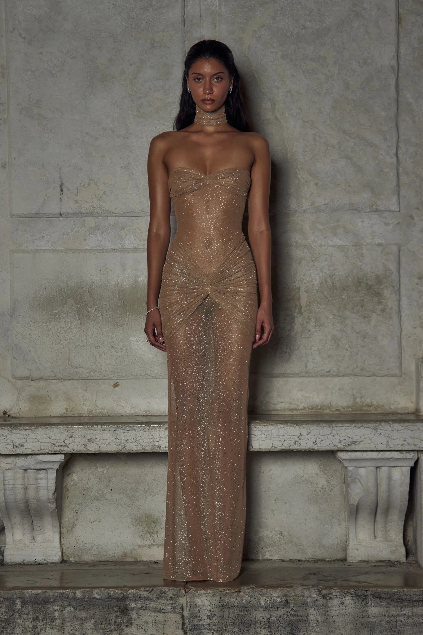 Indulge in luxury with The Starlite Dress in Diamond Sand. This strapless stretch gown boasts a chic collar, silicone gripper for a secure neckline, and an invisible zipper with hook and eye closure. The removable power mesh lining provides the perfect fit for your special event.