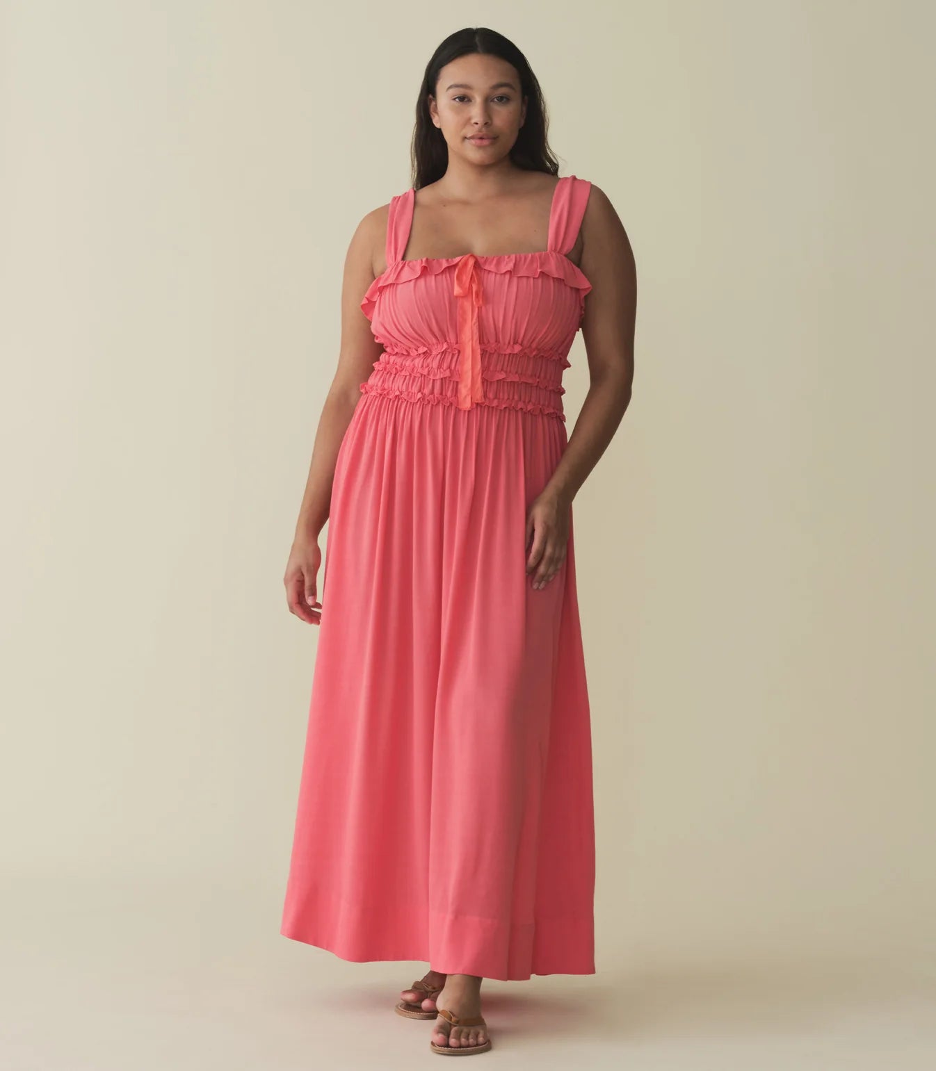 The Carolynn Dress—in a lightweight blend of rayon and viscose—features a square neckline, a gathered bust, and a fitted bodice framed with petite ruffles. Elastic lends give to the bust and waist, giving way to a swingy, ankle-length skirt.