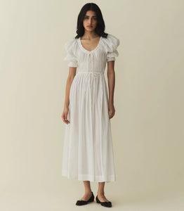 In a soft, lightweight blend of organic cotton and viscose, our beloved Ischia Dress—a Favorite Character that first made its debut in Spring 2021—features double-puffed sleeves and a scoop neckline adorned with petite ruffles and a functional center tie. A smocked bodice with an adjustable waist tie gives way to an ankle-grazing A-line skirt.