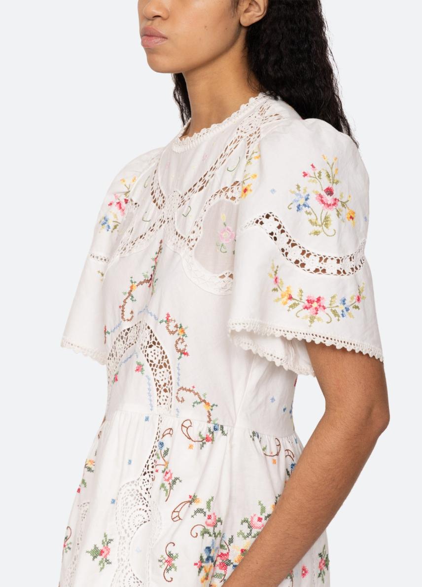 The Edwina Dress exudes intricate cross stitch embroidery, delicate lace trim, and charming puff sleeves. With its elegant ties at the back, this dress is perfect for any occasion. Experience timeless beauty and femininity in the Edwina Dress. Revive your wardrobe with this must-have piece!