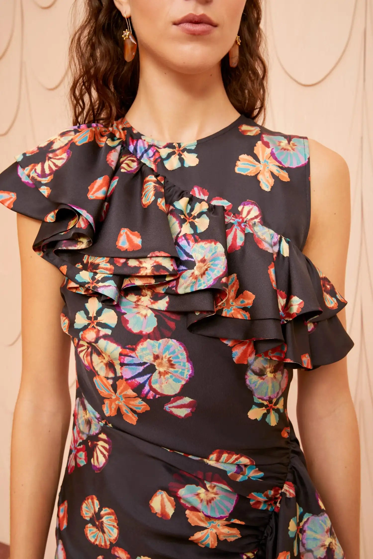 Expertly crafted from luxurious silk, the Candace Dress showcases a stylish brushstroke bloom pattern against a dark backdrop. Delight in the whimsical placement of rippling ruffles that add a touch of playfulness to this elegant design. Elevate your wardrobe with this unique and sophisticated piece.