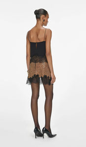Elevate your evening wardrobe with the Champagne Crystal Set—a dazzling combination of a relaxed-fit chainmail top and a flirtatious mini skirt. The top features champagne crystals, lace-trimmed hem, button-back closure, and full lining for comfort and polish. The matching fitted mini skirt, detailed with delicate lace trim and a back zipper, offers subtle allure with its minimal stretch and unlined finish. 