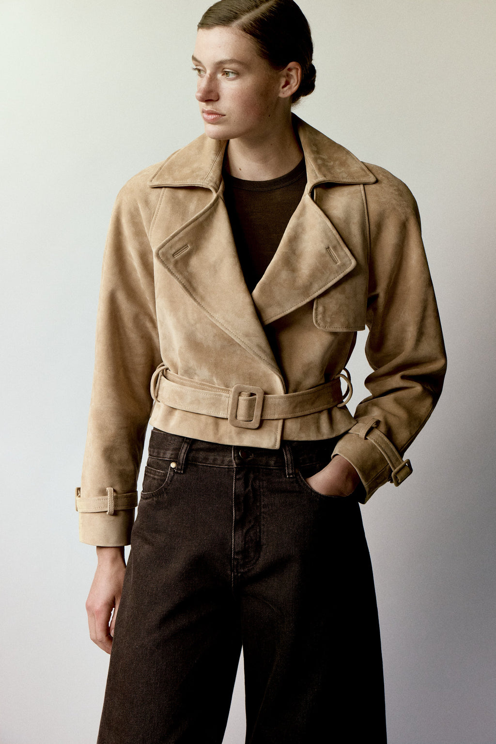The Millie Suede Jacket by Ducie reimagines the classic trench with modern flair. This cropped silhouette features an oversized collar that commands attention, while adjustable belts at the hem and sleeves offer customizable styling and a polished finish. Effortlessly versatile, it's the ideal layer for elevating your spring and summer wardrobe with contemporary edge and timeless sophistication.