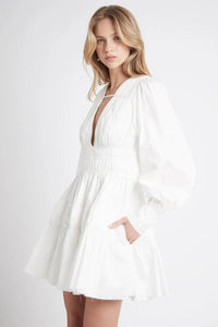 This Fallingwater Gathered Mini Dress by Aje showcases a deep V-neckline highlighted with delicate self-bind threading and elegant ruching panels that sculpt the silhouette. The gathered waist enhances shape, while side seam pockets add functional detail. Blouson sleeves gathered into wide cuffs offer a refined yet comfortable fit. Fully lined and featuring an invisible center back zipper, this dress provides both sophistication and ease, making it an impeccable choice for refined occasions.