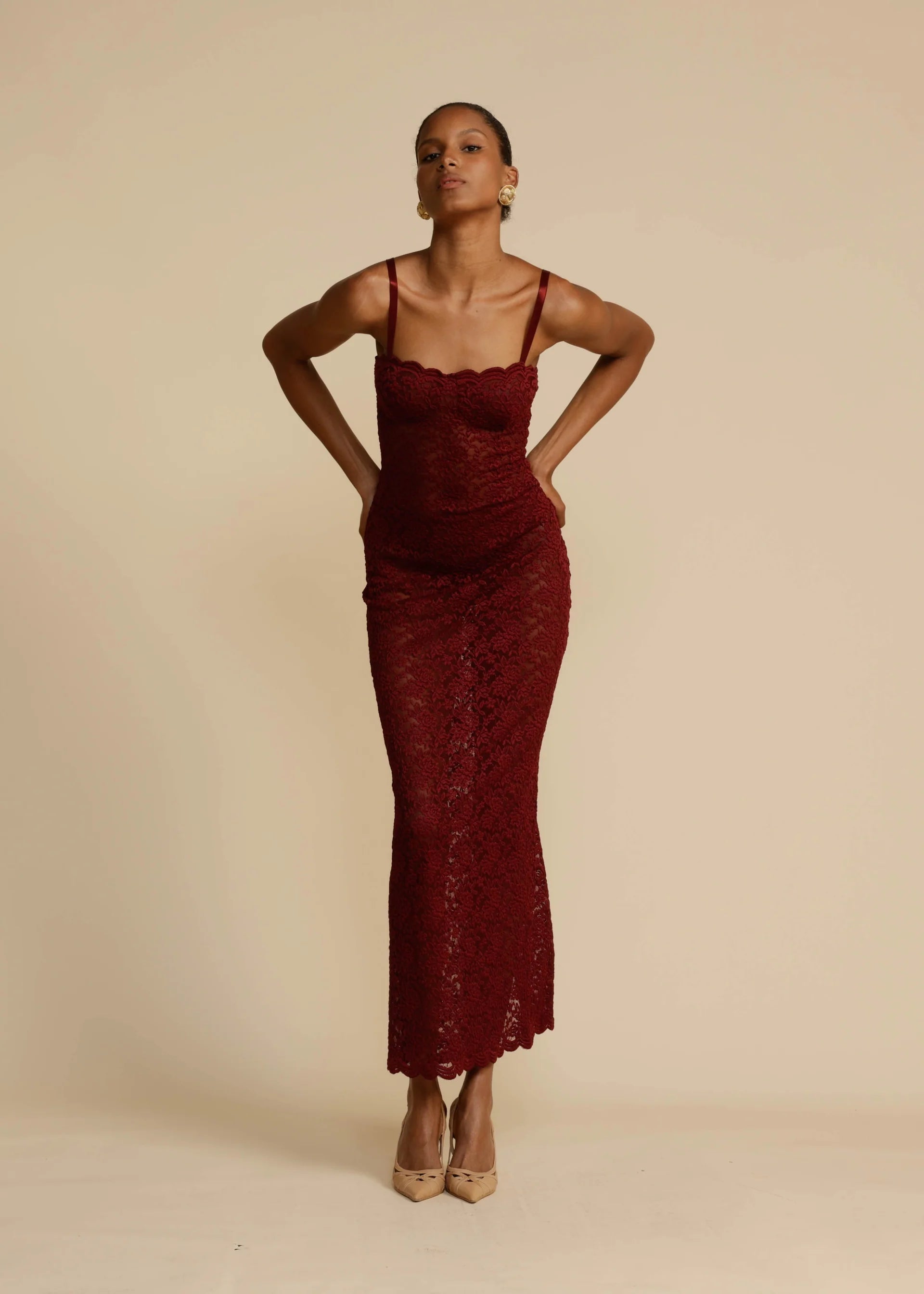 Elevate your evening look with Margot Lace Dress. This vintage-inspired lace dress in deep Wine exudes seductive allure and classic glamour. Featuring a semi-sweetheart neckline and a floor-length maxi with a center back split, Margot compliments your curves and allows for custom adjustments with gold fastenings on the shoulder straps. Lined at the bust for coverage and support, Margot is the perfect blend of comfort and sophistication.