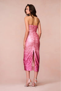 Introducing the Stasia Midi Dress, the star of your next party. Made from a luxurious sequin sheathing fabric, this dress features a stunning ombre pattern in shades of light pink to deep fuchsia. Shimmer and shine all night long with added glitter details. Elevate your event or holiday look with LoveShackFancy's signature sparkle.