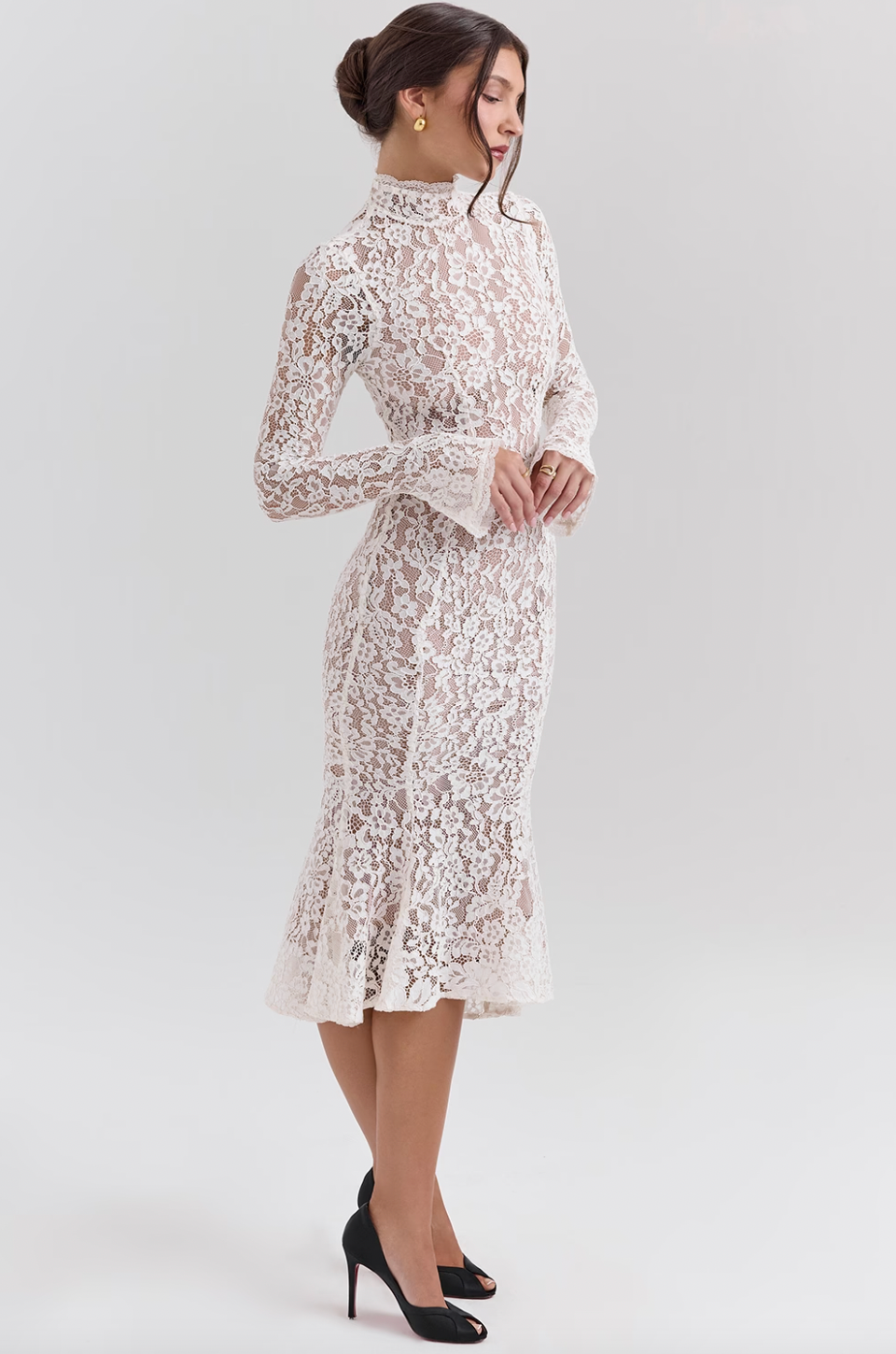 Get ready to turn heads with the Sophia Midi Dress. This dress combines modern flair and romantic elegance. Its body-hugging silhouette, high neck, and long sleeves beautifully highlight your shape while keeping it sophisticated. The ivory lace adds a touch of texture, and the fluted hem and cuffs add a playful twist to this timeless design.