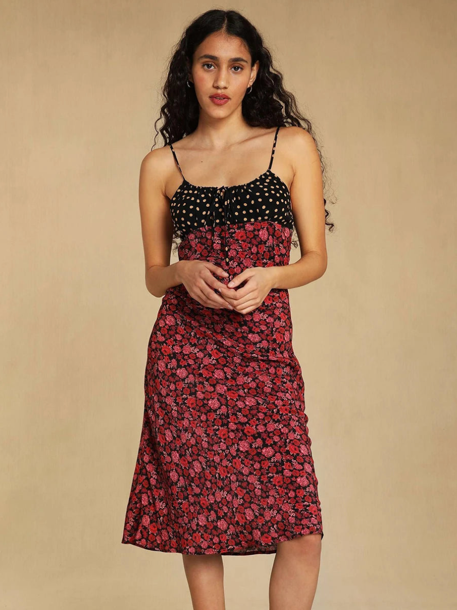 Elevate your summer wardrobe with our Daria Dress. This midi dress features delicate spaghetti straps and a feminine rose floral print. The tie belt cinches at the waist, creating a flattering silhouette. Sleeveless and elegant, this dress is perfect for any holiday or special occasion. Embody vintage charm with this exclusive piece.