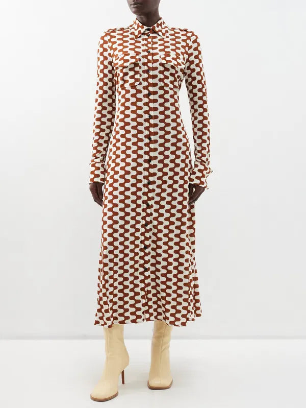 Embrace retro chic with Proenza Schouler's Printed-Jersey Maxi Shirt Dress. The brown and cream zigzag motif adds a playful touch to this sophisticated dress, made from comfortable jersey with a flattering tie-back waist and elegant fold French cuffs. Elevate your wardrobe with this exclusive piece.