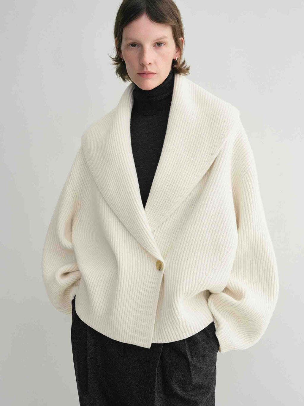 Elevate your layering with this oversized shawl-lapel cardigan by Toteme. Crafted from soft ribbed wool, it offers warmth and cozy comfort while its wide armholes and sleeves ensure effortless movement. The crossed front with button fastening adds a stylish, secure fit, and the curved shawl lapels bring a sophisticated touch to any outfit. Perfect for chic, relaxed days or cozy evenings indoors.