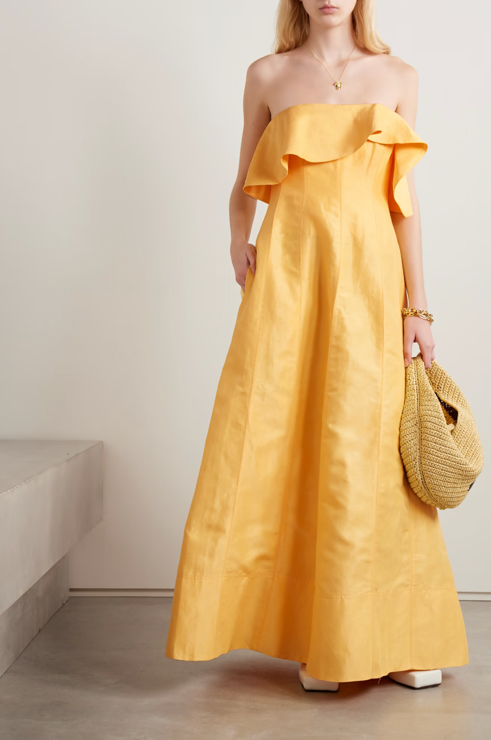 Inspired by Australia's radiant landscapes, the Shallows gown captures sunshine in its luminous marigold hue. This strapless stunner features delicate ruffles framing the neckline and internal boning that sculpts and supports your silhouette. Crafted from breathable linen-blend fabric, the voluminous skirt moves gracefully with every step, delivering both comfort and undeniable elegance for your most memorable occasions.