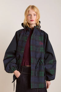 Embrace rainy days with the Liu Coat from Damson Madder, featuring a classic Black Watch tartan design crafted from shower-resistant fabric. Its balloon-style cuffs, adjustable hood, and cinchable waist offer both comfort and a flattering silhouette, while signature 'DM' embroidery adds a touch of distinction. Equipped with practical pockets and thoughtful details, this coat effortlessly combines style and functionality, making it the perfect shield against wet weather.