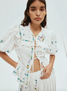 Effortlessly elevate your wardrobe with the Willa Embroidered Set. The tie front top with self-covered eyelet buttons and frill yoke detail add a touch of femininity, while the embroidered motif detail adds a unique touch. The elasticated drawstring waist and balloon sleeves provide a comfortable fit, making this set a must-have for any occasion.