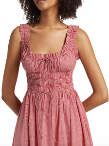 Elevate your wardrobe with DOEN's Emmaretta Shirred Gingham Midi Dress. Made from luxurious organic cotton-voile, it boasts vibrant gingham checks and a shirred bodice with slim, adjustable ties for a flattering fit. Complete with playful ruffled straps and a floaty skirt, this dress is the perfect blend of femininity and elegance.