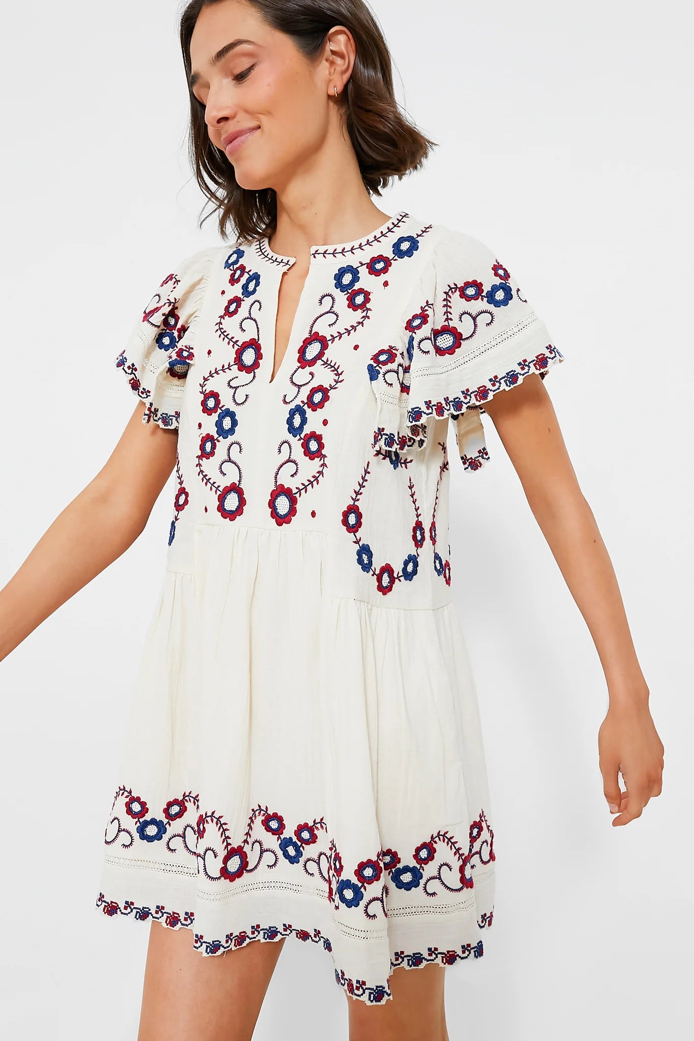 The Soren Embroidery Short Sleeve Dress by Sea New York features a split V-neckline and delicate embroidered detailing, combining elegance with effortless wearability. Its short flutter sleeves and gathered skirt create an A-line silhouette that offers a relaxed yet refined fit, ideal for versatile styling. In a cream multi palette, this mini dress balances romantic charm with modern ease, making it perfect for both casual days and more polished occasions. 