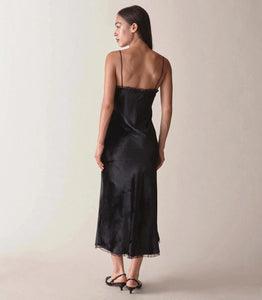 Rendered in sumptuous velvet, the Calsi Dress is a take on a ‘30s-style slip dress. It features ultra-skinny silk satin straps, bust darts for structure, and shirring at the bust for a subtle sweetheart neckline. A fitted waist gives way to an A-line skirt that falls to mid-calf, while petite silk organza ruffles adorn the neckline and hem.