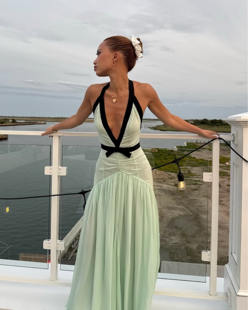 The Siren Dress in Mint by Helsa is engineered for those who embrace bold fashion statements. This sleeveless bodycon maxi features a striking plunging V-neckline and open back that exude confidence and allure. Contrast mesh patchwork adds contemporary visual interest, while pleated skirt detailing creates graceful movement. The secure halter construction delivers support without compromising the dress's daring aesthetic. 