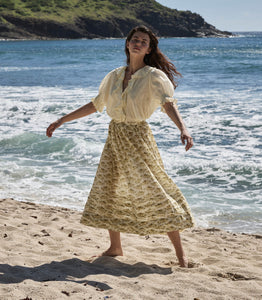 Elevate your wardrobe with the Marcie Skirt in Citron Rosier Floral by Doen, designed for timeless elegance and comfort. Crafted from a soft organic cotton and viscose blend, this high-waisted skirt features a flowing ankle-length silhouette adorned with a vintage-inspired poppy field print. Pintuck details and an invisible side zipper provide a flattering fit, making it a versatile choice for both casual days and special occasions. Experience effortless style with every wear.