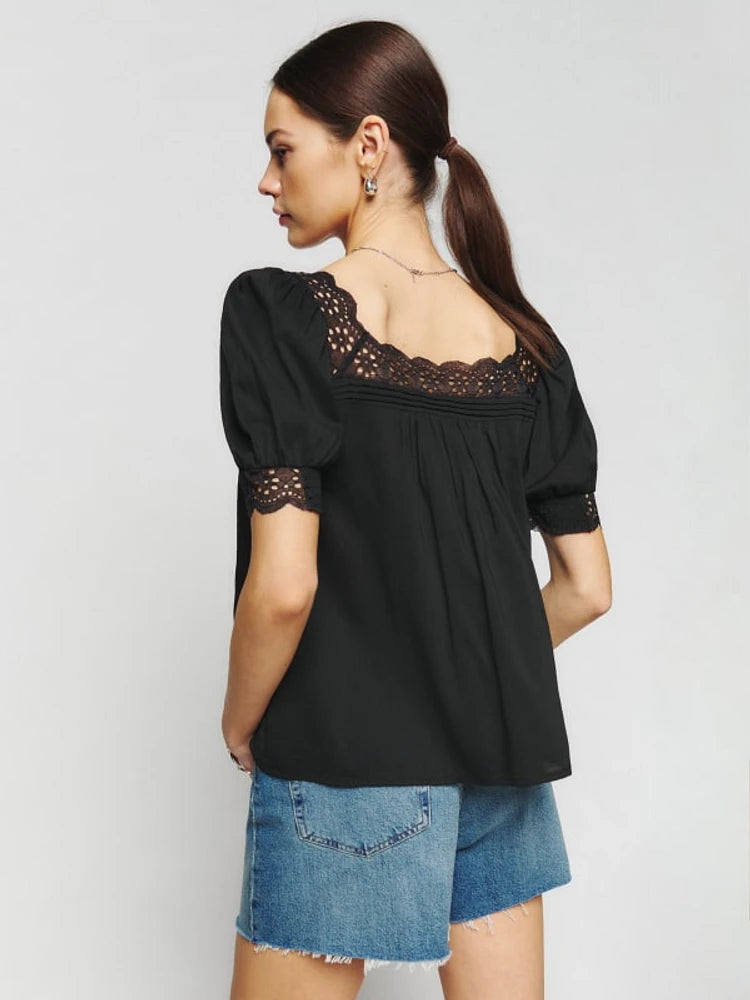 Introducing the Wanda Top from Reformation - the perfect addition to your wardrobe for effortless style. With a relaxed fit and a square neckline, this top exudes a casual yet chic vibe. Plus, the short puff sleeves add a touch of femininity. Shop now and elevate your look with ease.