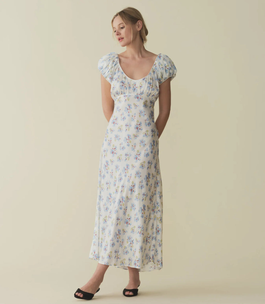 In a luminous blend of silk and viscose, the Florencia Dress—which takes cues from ‘30s gowns—features a soft scooped V-neckline, ruching at the bust and sleeves, and an ankle-length bias-cut skirt.