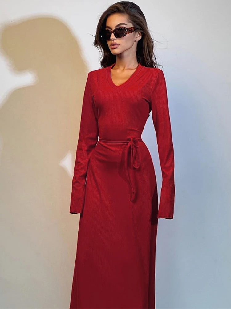 Boost your confidence with our elegant Dora Dress! This maxi dress features a figure-flattering fit, a stylish V-neck with lace-up detailing, and long sleeves. Perfect for a night out, this dress is made from soft knit fabric in a striking red hue. Upgrade your wardrobe and stand out at your next party!