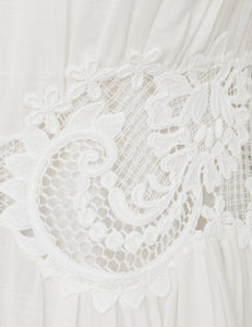 This cotton mini dress features short sleeves and a front center placket for a polished look. Its delicate scalloped hemline and intricate placement trim add refined detailing, while the included separate slip ensures comfortable coverage and smooth layering. Ideal for warm weather, this dress combines breathable fabric with elegant design elements.