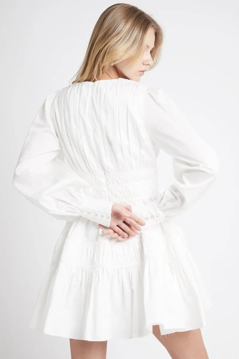 This Fallingwater Gathered Mini Dress by Aje showcases a deep V-neckline highlighted with delicate self-bind threading and elegant ruching panels that sculpt the silhouette. The gathered waist enhances shape, while side seam pockets add functional detail. Blouson sleeves gathered into wide cuffs offer a refined yet comfortable fit. Fully lined and featuring an invisible center back zipper, this dress provides both sophistication and ease, making it an impeccable choice for refined occasions.