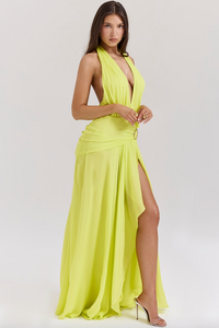 Elevate your style with the Backless Halter Maxi Dress, perfect for special occasions. Made from luxurious Georgette fabric, this dress features a plunging halter neck and silver-tone waist hardware for a touch of elegance. The open back, adorned with spiral frill ties, adds a beautiful detail to this dress.