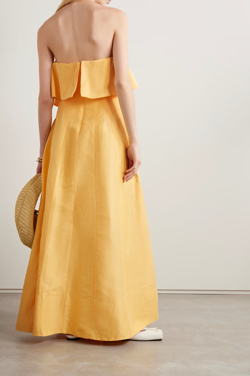 Inspired by Australia's radiant landscapes, the Shallows gown captures sunshine in its luminous marigold hue. This strapless stunner features delicate ruffles framing the neckline and internal boning that sculpts and supports your silhouette. Crafted from breathable linen-blend fabric, the voluminous skirt moves gracefully with every step, delivering both comfort and undeniable elegance for your most memorable occasions.