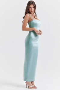 Indulge in luxury with our 'Constanza' dress, made from exquisite shimmering satin in a stunning light jade color. The corset-style bodice contours your curves while the delicate scalloped trim and barely-visible straps add a touch of elegance. The flowing maxi skirt with a slit allows for graceful movement and is fully lined for a smooth finish. 