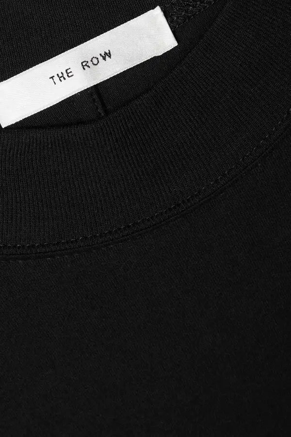 The Fedrino Organic Cotton-jersey T-shirt by The Row offers timeless comfort with a soft, breathable fabric perfect for everyday wear. Its relaxed fit and dropped shoulders provide effortless style, while the slightly wider crewneck adds a modern touch. The subtle back seam enhances the streamlined look, making this tee a versatile staple you’ll turn to season after season. Available in a variety of colors to suit your personal style.