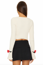 Load image into Gallery viewer, Elevate your style with the For Love &amp; Lemons Roxana Cardigan. This luxurious midweight chenille ribbed knit cardigan features delicate rosette appliques on the front snap button closure and removable chenille rosettes on the cuffs. Unlined and in a timeless white color, it&#39;s perfect for adding a touch of sophistication to any outfit.
