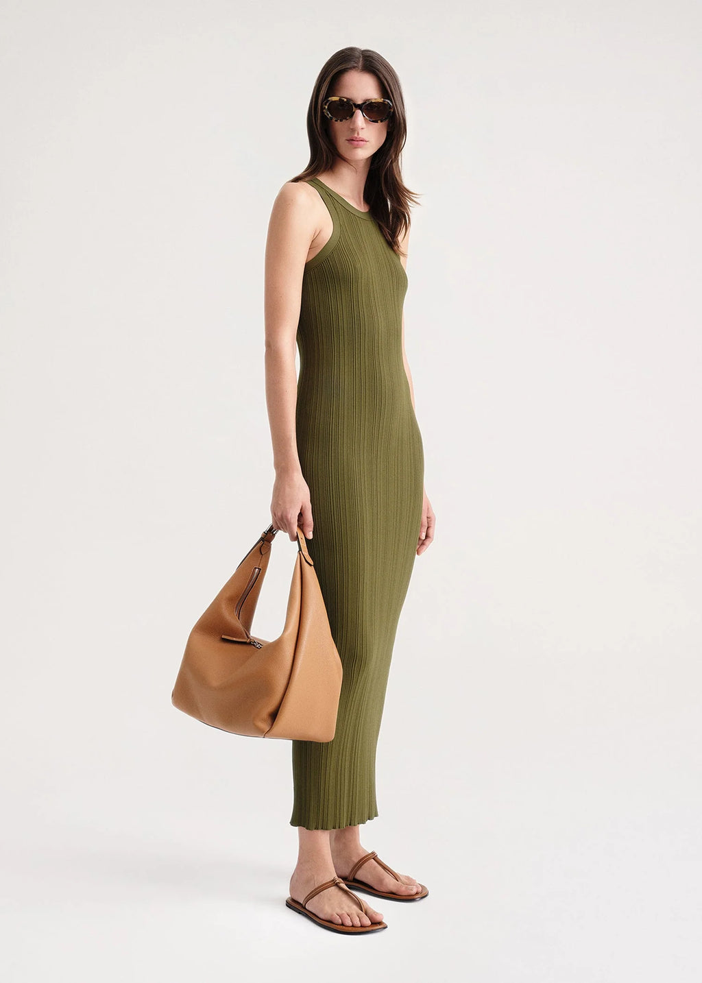 Elevate your style game with our TOTEME Khaki Seamless Midi Dress. Made from a luxurious rib knit blend of viscose and recycled nylon, this dress molds to your body for a flawless fit. Perfect for any occasion, this dress exudes sophistication and exclusivity.