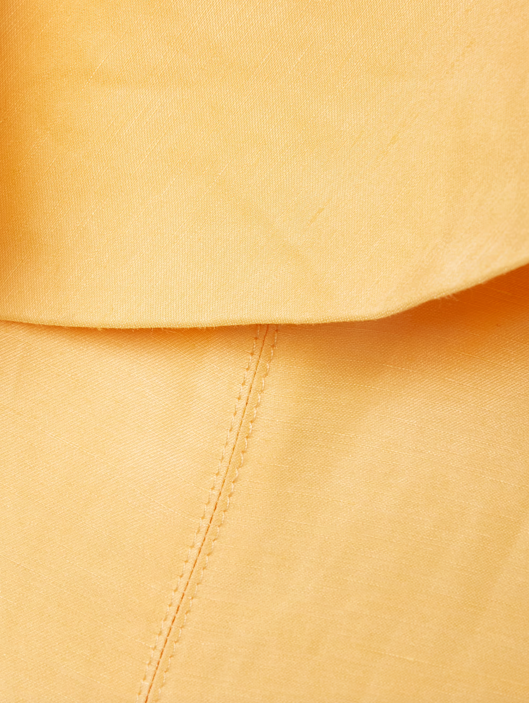 Inspired by Australia's radiant landscapes, the Shallows gown captures sunshine in its luminous marigold hue. This strapless stunner features delicate ruffles framing the neckline and internal boning that sculpts and supports your silhouette. Crafted from breathable linen-blend fabric, the voluminous skirt moves gracefully with every step, delivering both comfort and undeniable elegance for your most memorable occasions.