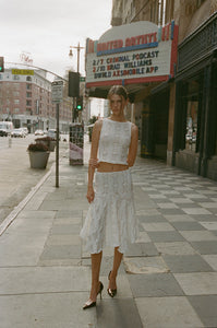 Elevate your summer wardrobe with the Ensemble Maeve 2 piece-set. The white, casual tank top is elevated with a trendy hollow out patchwork design, while the long skirt adds a touch of elegance. This sexy maxi skirt set allows you to effortlessly show off your personal style and stand out in any crowd. Perfect for any warm weather occasion.