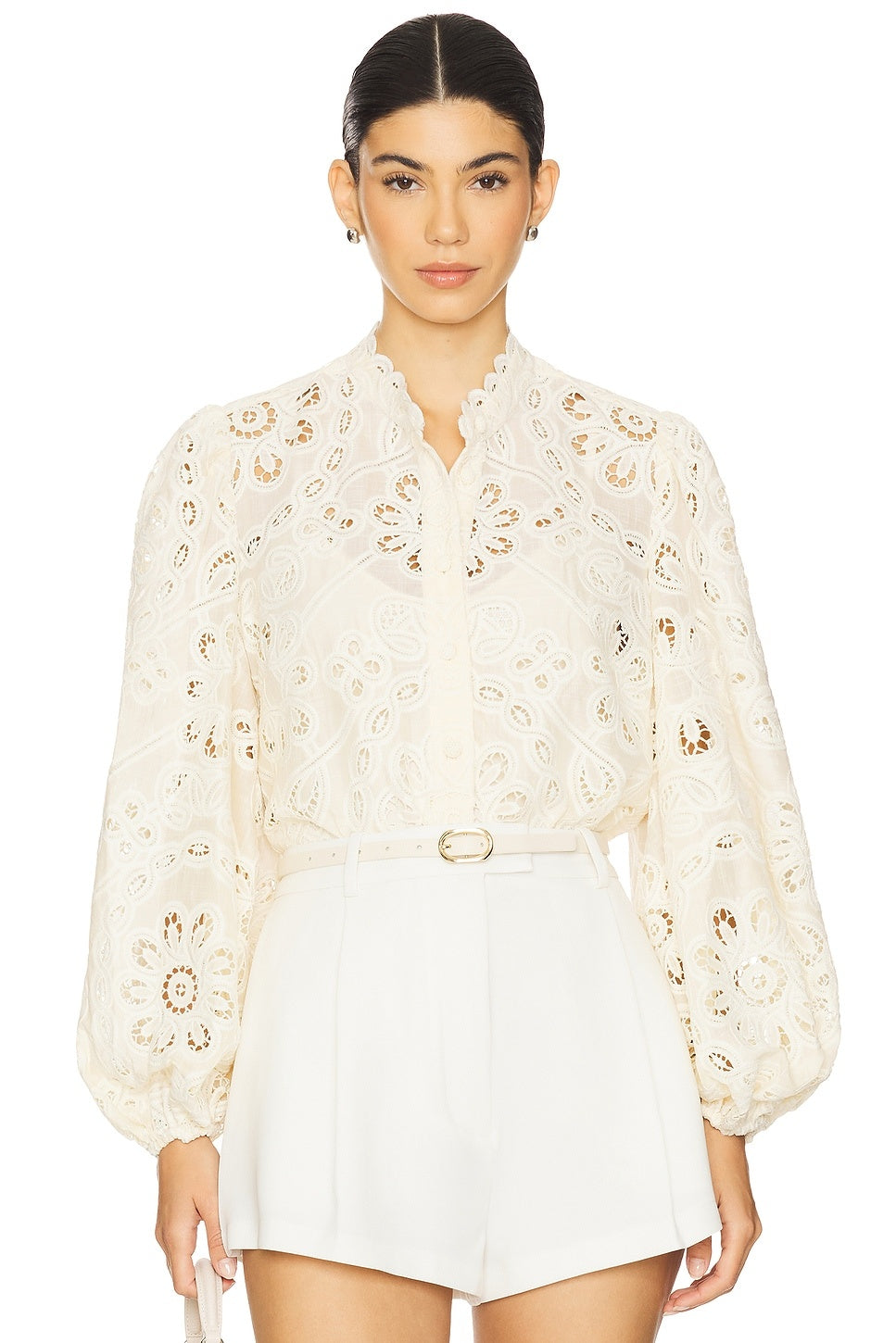 Elevate your everyday style with the Rhiannon Embroidered Blouse by Zimmermann, a charming piece that combines timeless elegance with modern flair. Featuring delicate floral embroidery that adorns the entire design, this blouse makes a sophisticated statement. The romantic puff sleeves with elastic cuffs create a flattering silhouette while maintaining comfort throughout the day. A convenient front button closure allows for effortless dressing and styling versatility. 