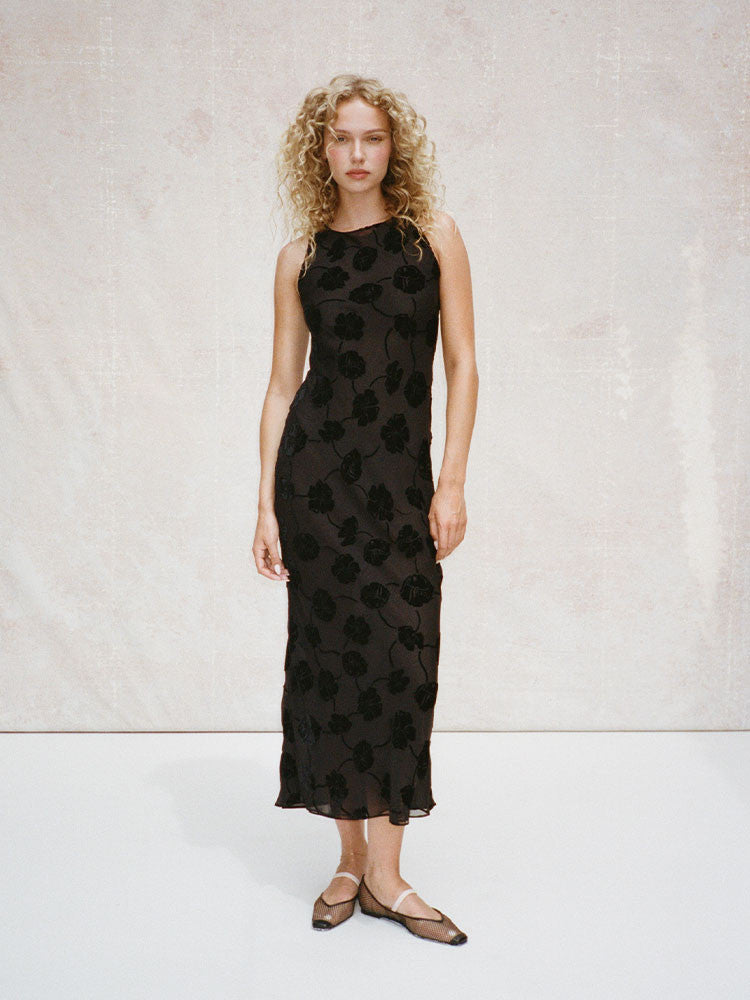 Chic and understated with the right amount of detail. The sheer top layer with tonal velvet flowers dotted all over creates the perfect floral for all you minimal Dreamgirls. The Carla with her boat neck and ankle length, is the silk dress you'll be reaching for...whether it's your day as the low key bride, as that woman all in black at the theatre with a dinner jacket and the perfect earrings, or simply as the Dreamgirl having lunch turning heads in either the ivory or black version.