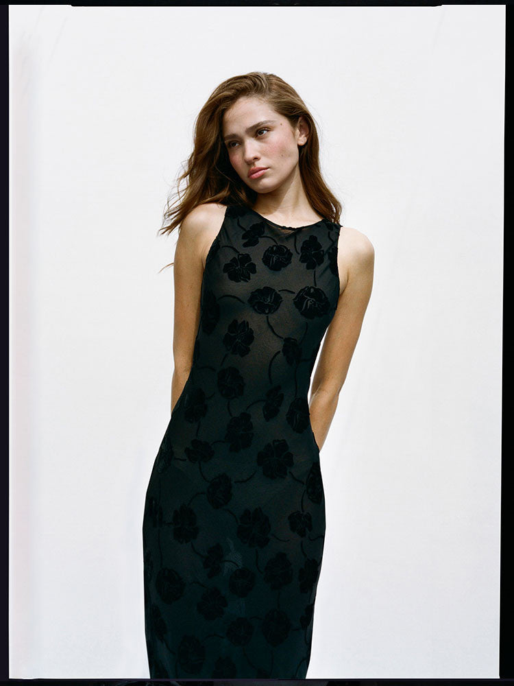 Chic and understated with the right amount of detail. The sheer top layer with tonal velvet flowers dotted all over creates the perfect floral for all you minimal Dreamgirls. The Carla with her boat neck and ankle length, is the silk dress you'll be reaching for...whether it's your day as the low key bride, as that woman all in black at the theatre with a dinner jacket and the perfect earrings, or simply as the Dreamgirl having lunch turning heads in either the ivory or black version.